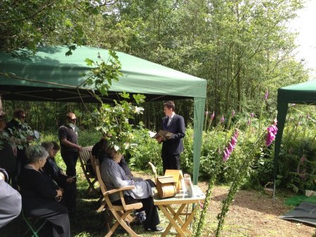 People gathered for heartfelt readings for funerals at Respect woodland green burial ground.