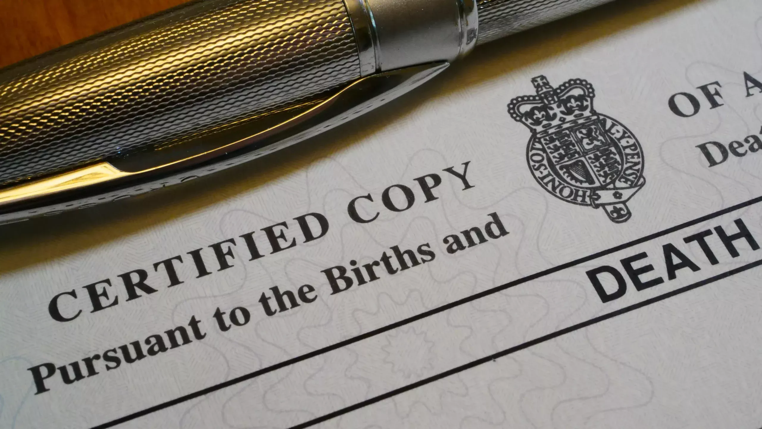 UK death certificate paperwork with pen