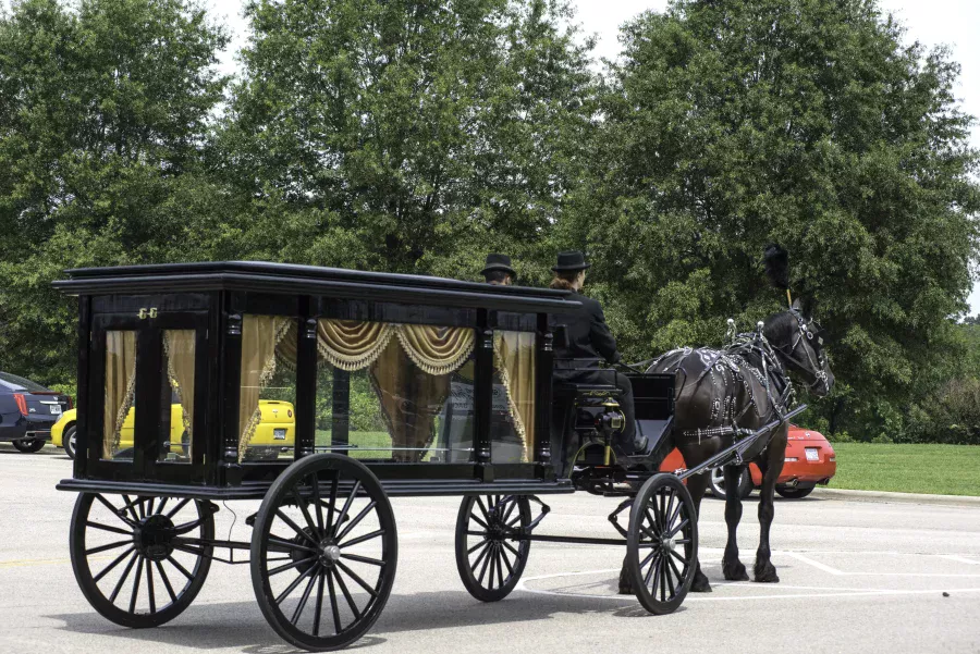 Coachmen driving to the woodland burial