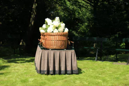 A green burial with a biodegradable coffin prepared for burial